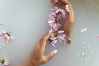 Delicate flowers float in a tranquil bath as a woman's hands reach out to touch them, indulging in the soothing effects of aromatherapy. In this post, we'll explore the many benefits of this ancient practice and how it can improve your overall wellbeing.