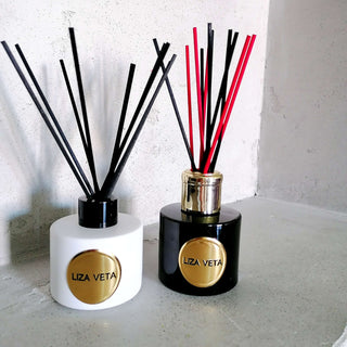 Black natural reed diffuser is placed in the bathroom.