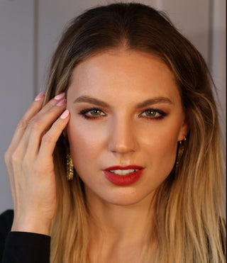 a woman with red lipstick explains how To Prepare Your Skin for Winter