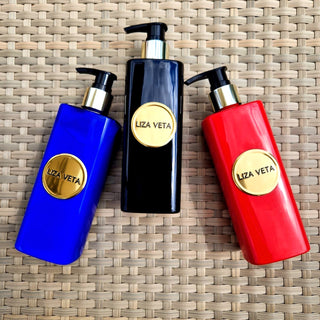 Hand and body lotions and washes in red, black and blue bottles.