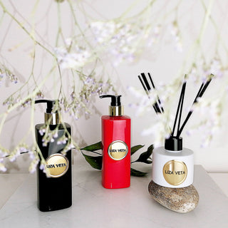 Body lotion, body wash and reed diffuser are on the table