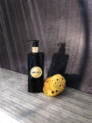 Hand and body wash in black bottle with lavender essential oil with natural body sponge